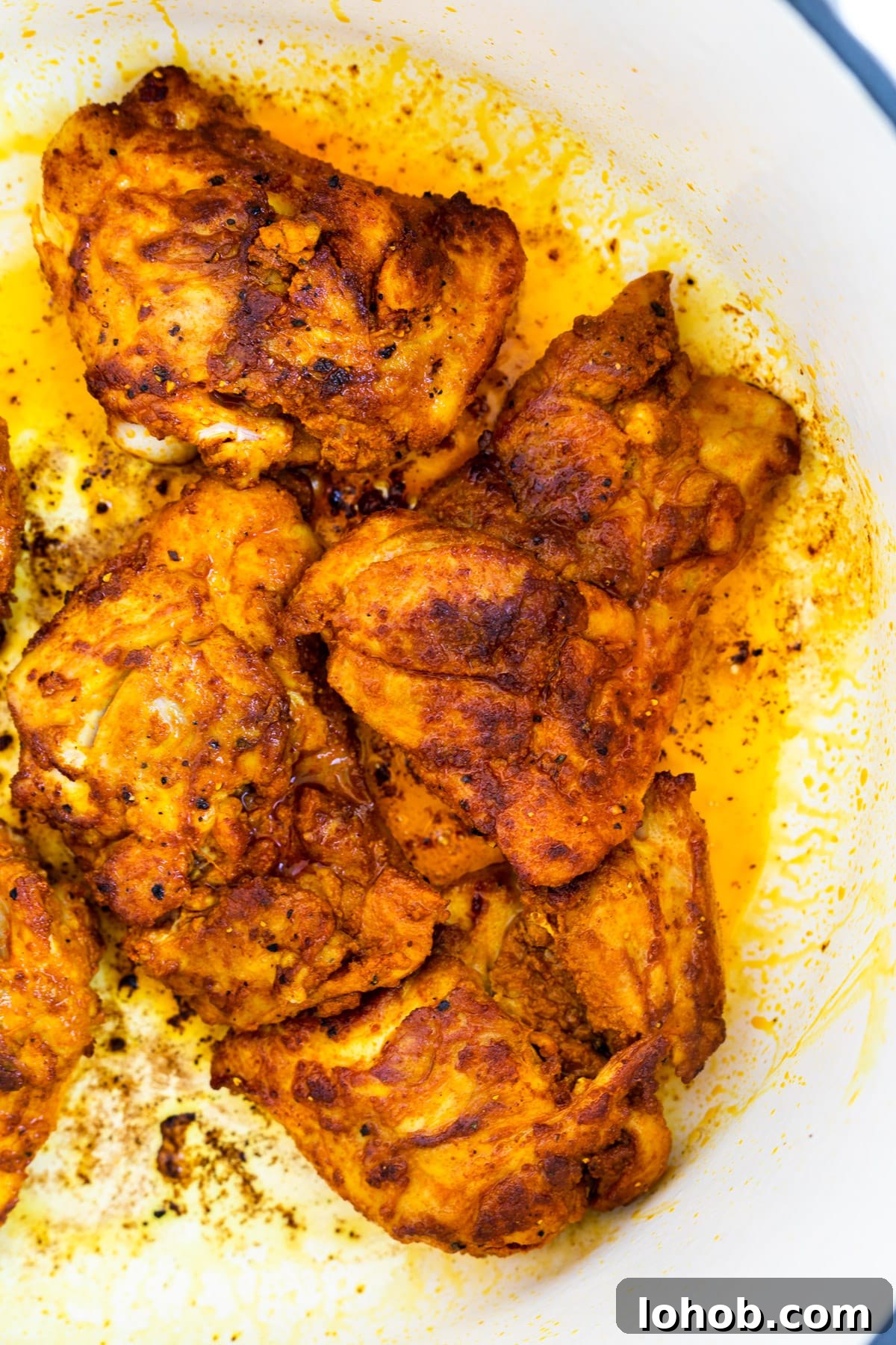 Authentic Spanish Chicken and Rice Recipe for Flavorful Dinner 3 Browned chicken thighs in a Dutch oven.