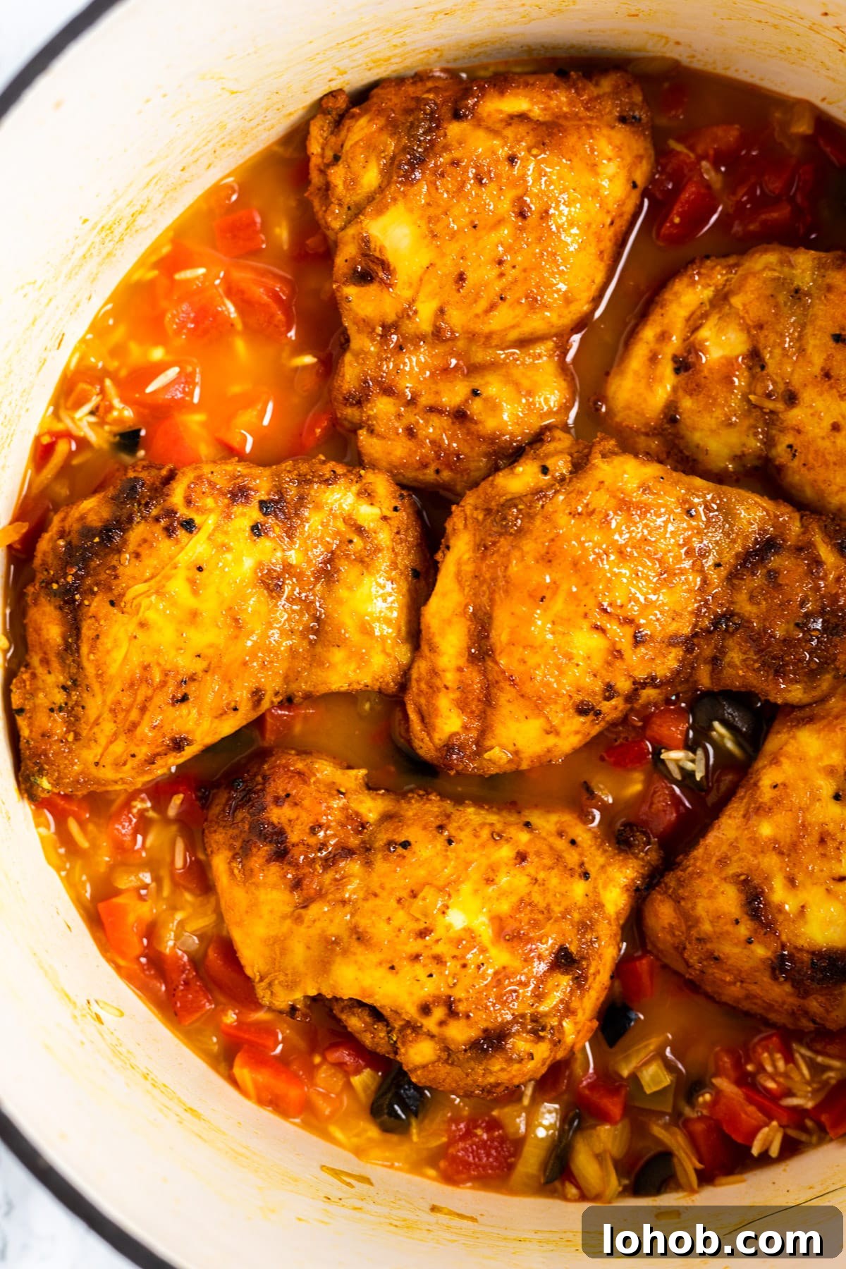 Authentic Spanish Chicken and Rice Recipe for Flavorful Dinner 6 Spanish chicken and rice in a Dutch oven before baking.