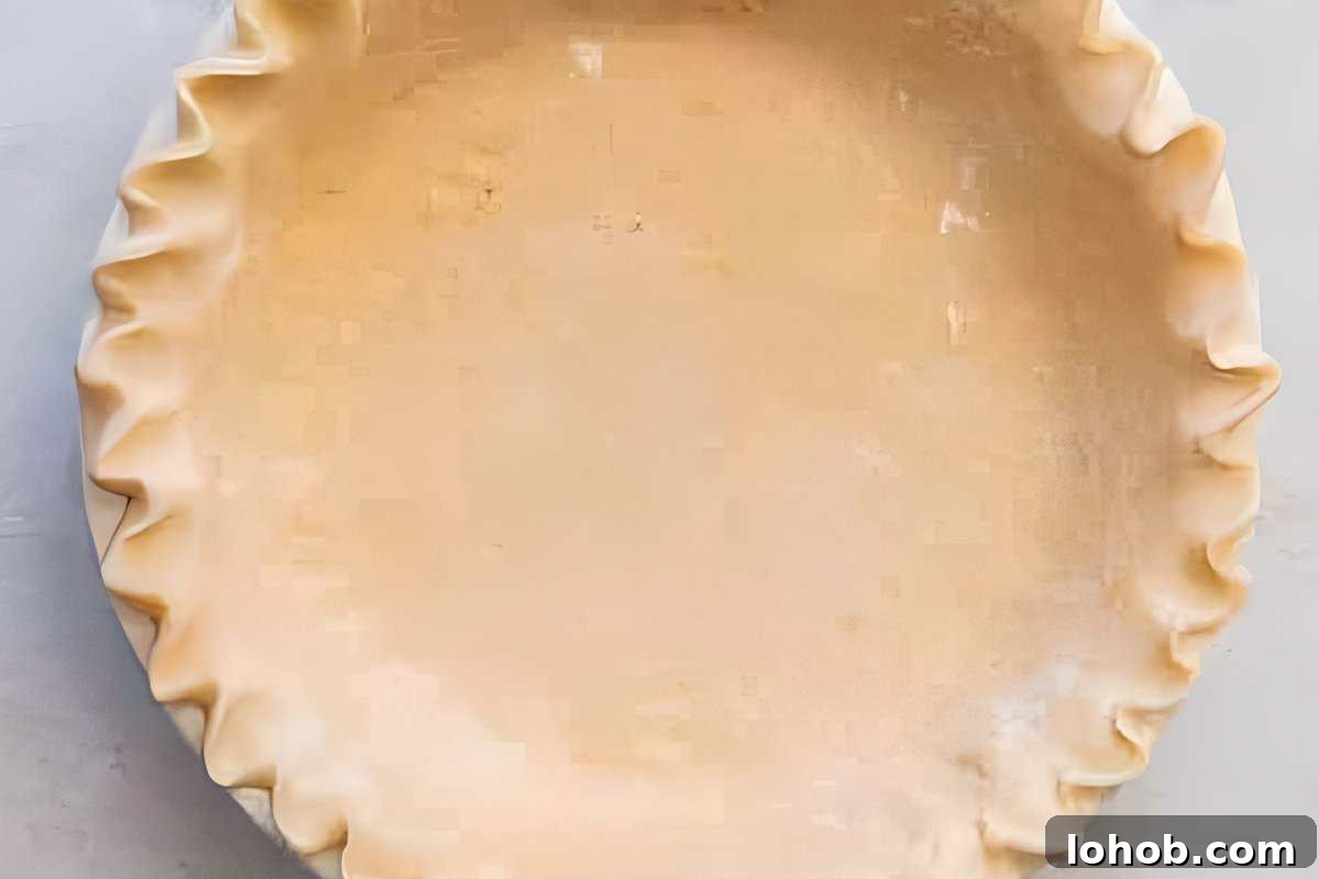 crimped pie crust in a pie dish.