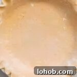 crimped pie crust in a pie dish.