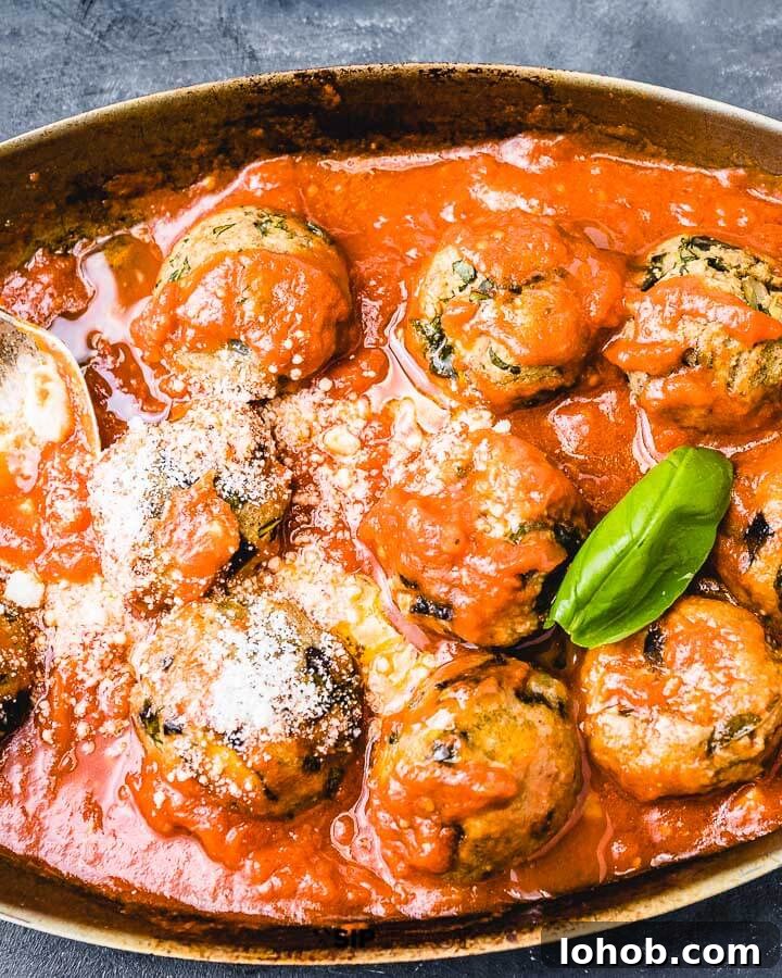 Eggplant meatballs in pan on blue background.