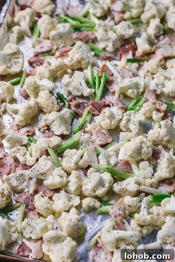 Crispy Roasted Cauliflower with Bacon and Green Onions 3 Cauliflower florets, bacon and green onions on a sheet pan.