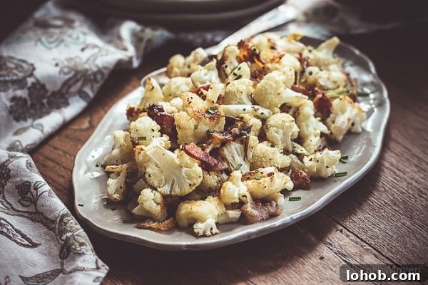 Crispy Roasted Cauliflower with Bacon and Green Onions 4 Roasted cauliflower with bacon and green onions on a platter.