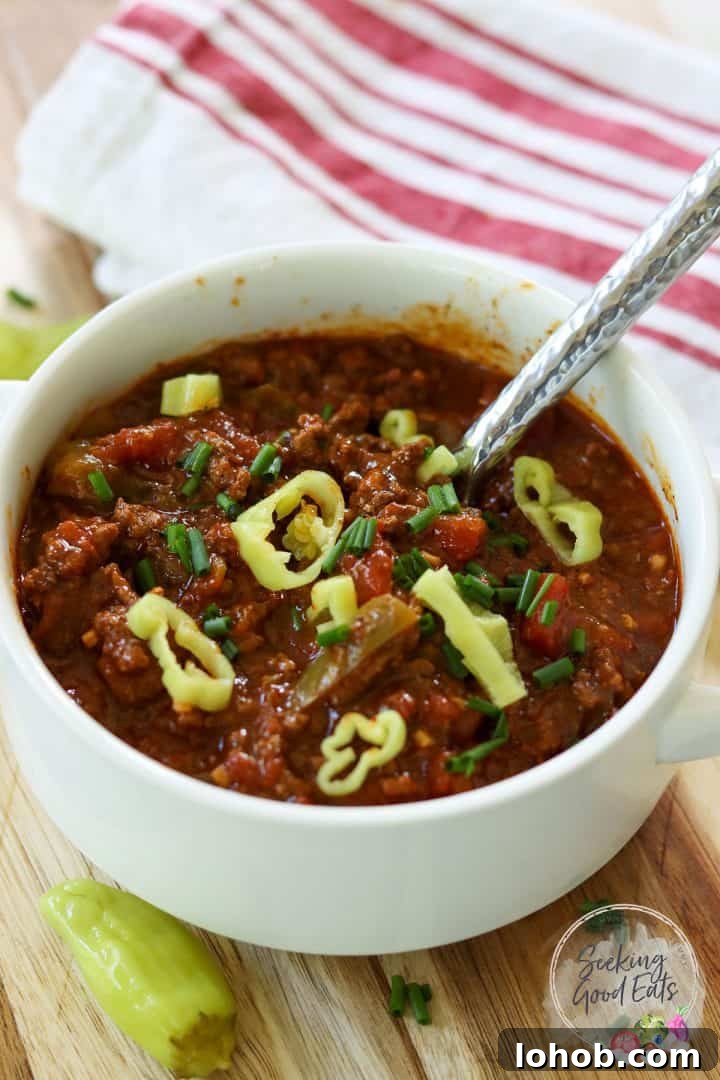 Texas-Style Crock Pot Chili Recipe (No Beans) 2 No bean chili served in a white bowl and garnished with sliced pepperoncini