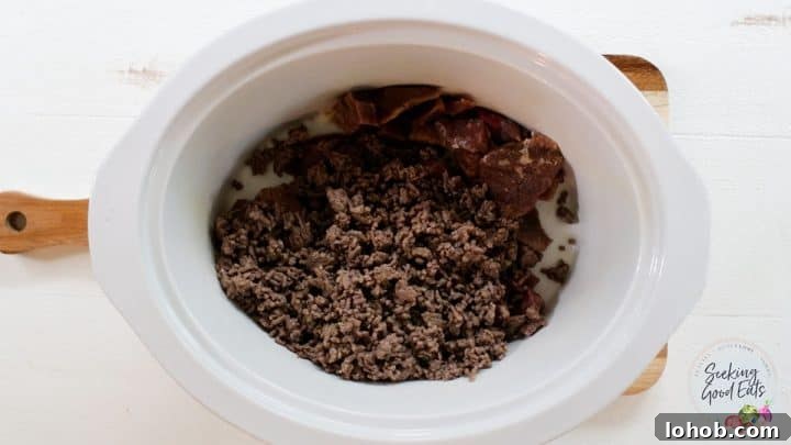 Texas-Style Crock Pot Chili Recipe (No Beans) 3 Adding cooked ground beef to the slow cooker
