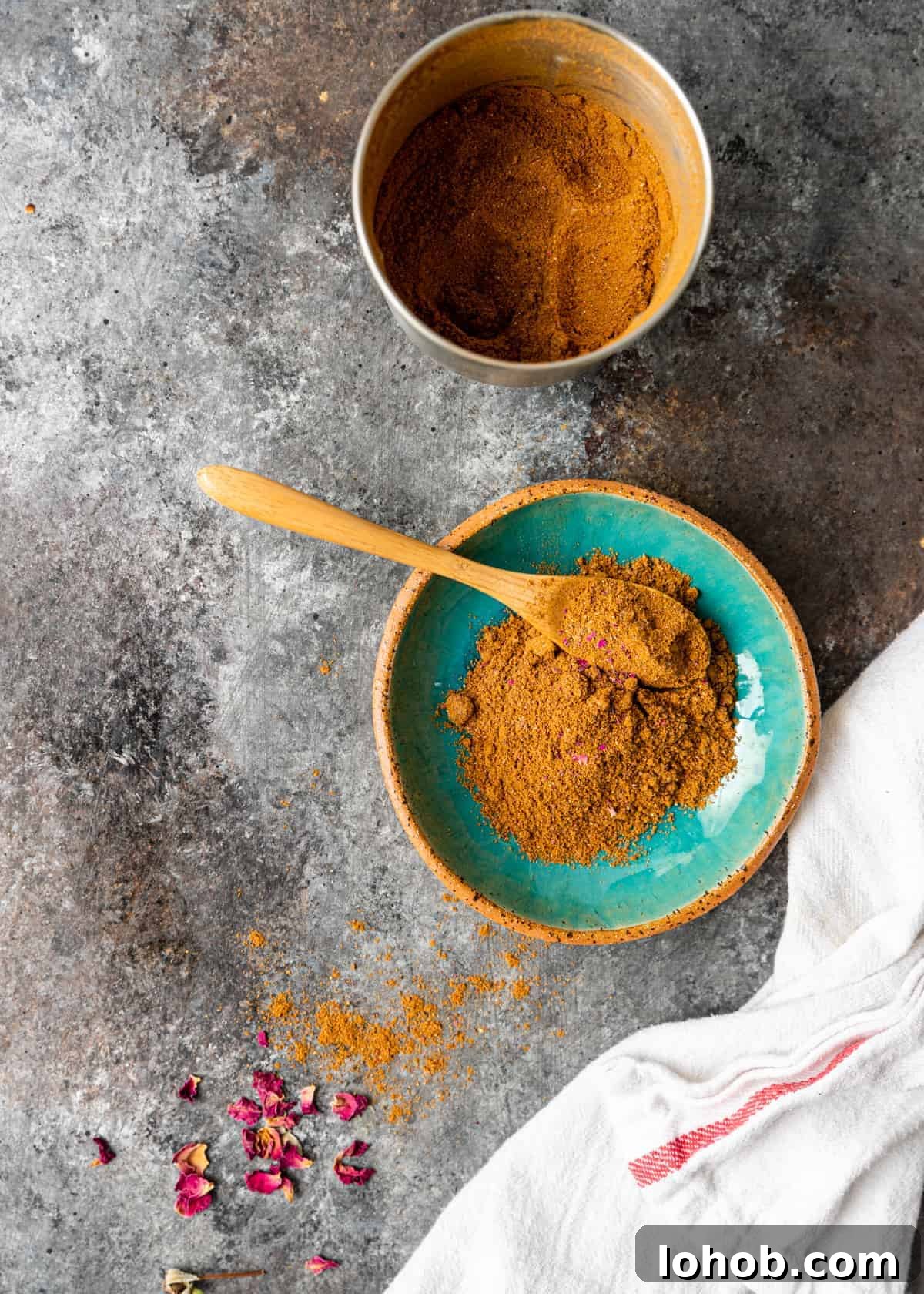 overhead: advieh spice mix in small glazed pottery bowl with wooden spoon