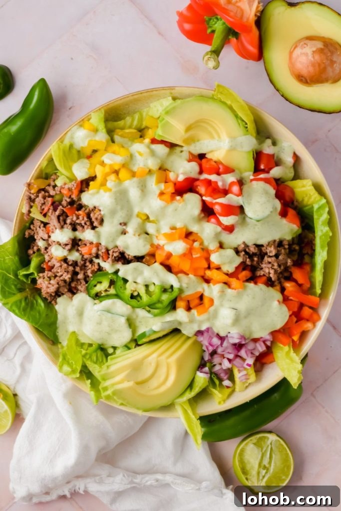 big bowl of ranch taco salad dressed with creamy jalapeño sauce before tossing.