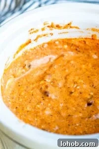Crockpot Chili Cheese Dip in slow cooker Crockpot chili cheese dip in a white slow cooker.
