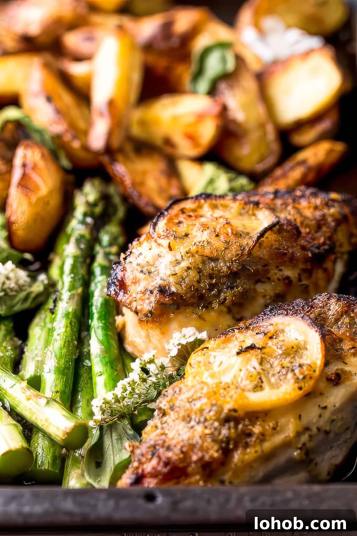 Sheet pan chicken and potatoes with lemon and herbs.