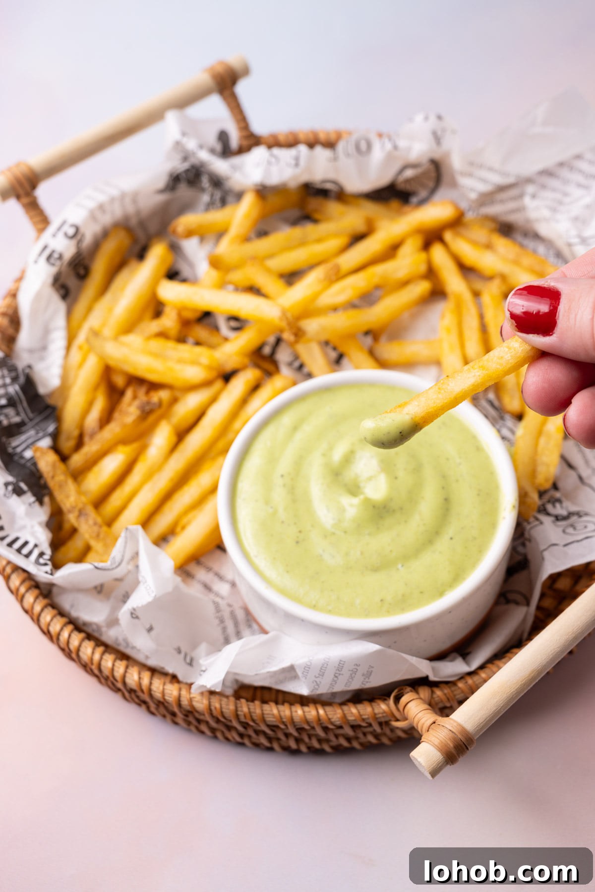 Dipping a French fry into creamy ranch made from avocado. 