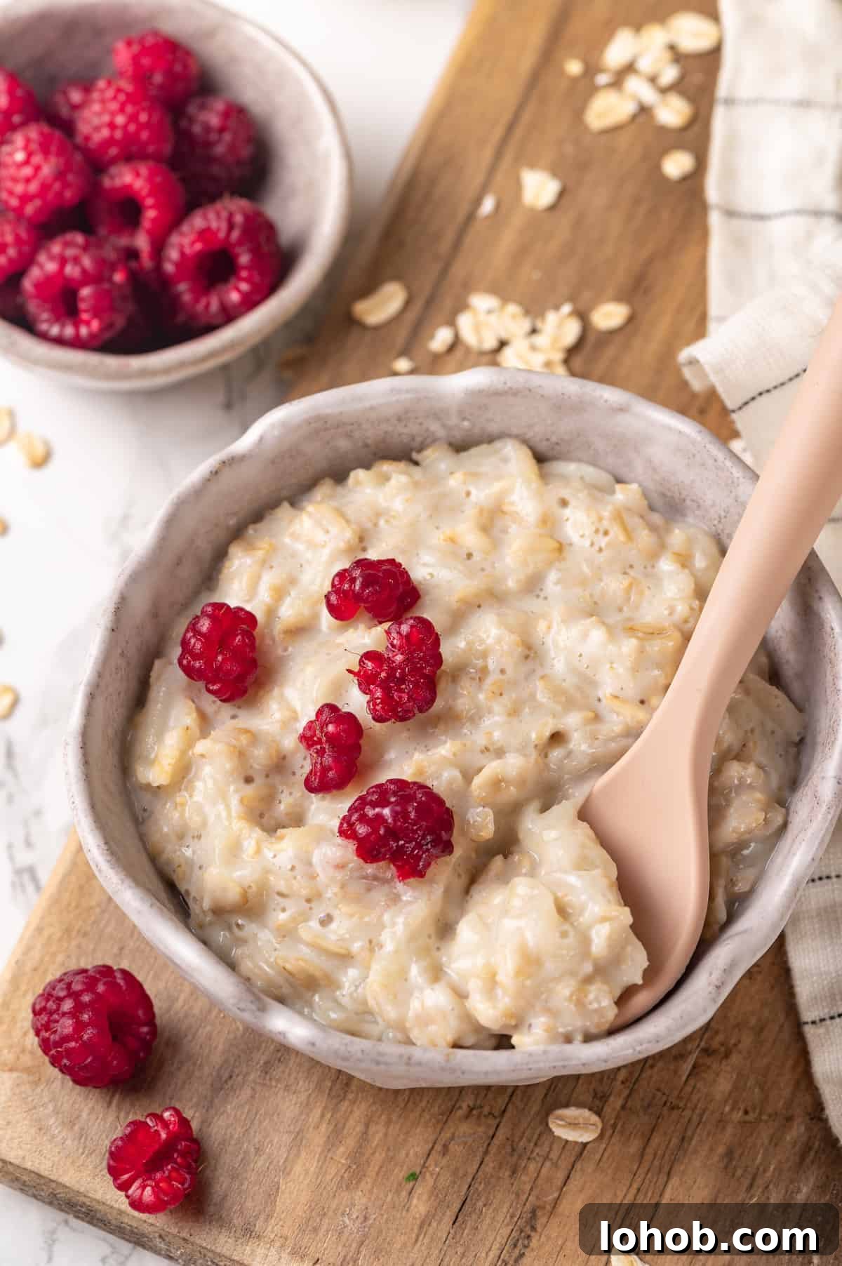 Homemade baby oatmeal is a great beginning food for infants transitioning to solid foods. Nutrient-dense, easy to digest, and simple to make! Baby oatmeal in bowl with spoon