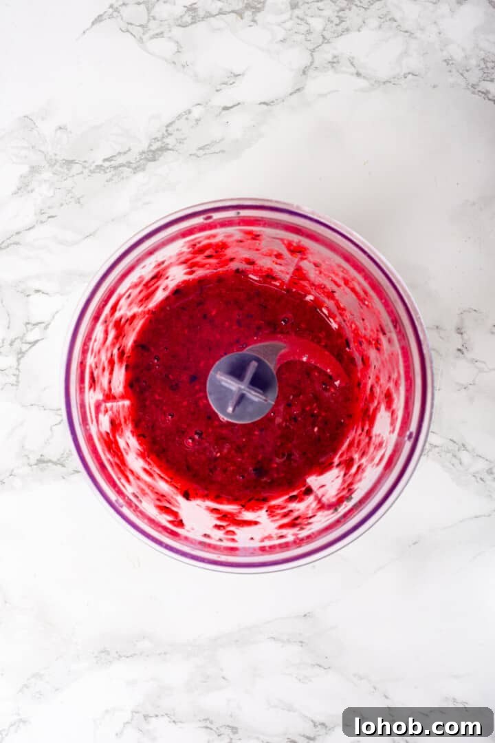 Homemade baby oatmeal is a great beginning food for infants transitioning to solid foods. Nutrient-dense, easy to digest, and simple to make! Overhead view of jam topping in food processor