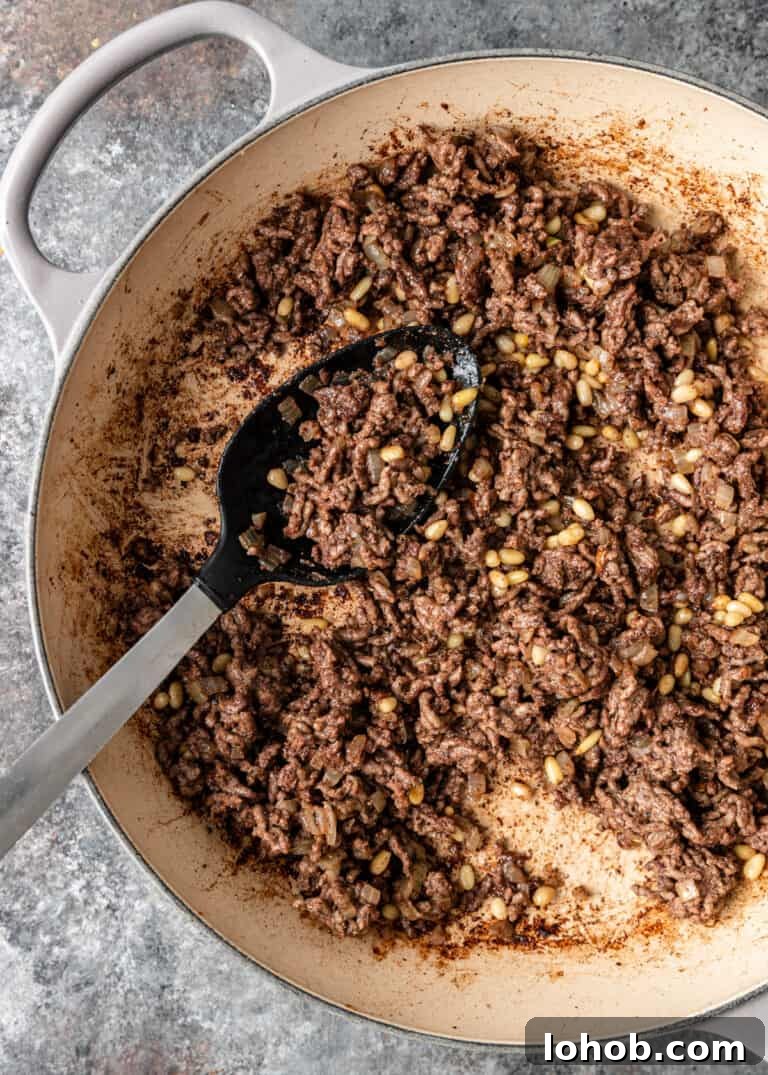 overhead: cooking ground meat in Dutch oven pot