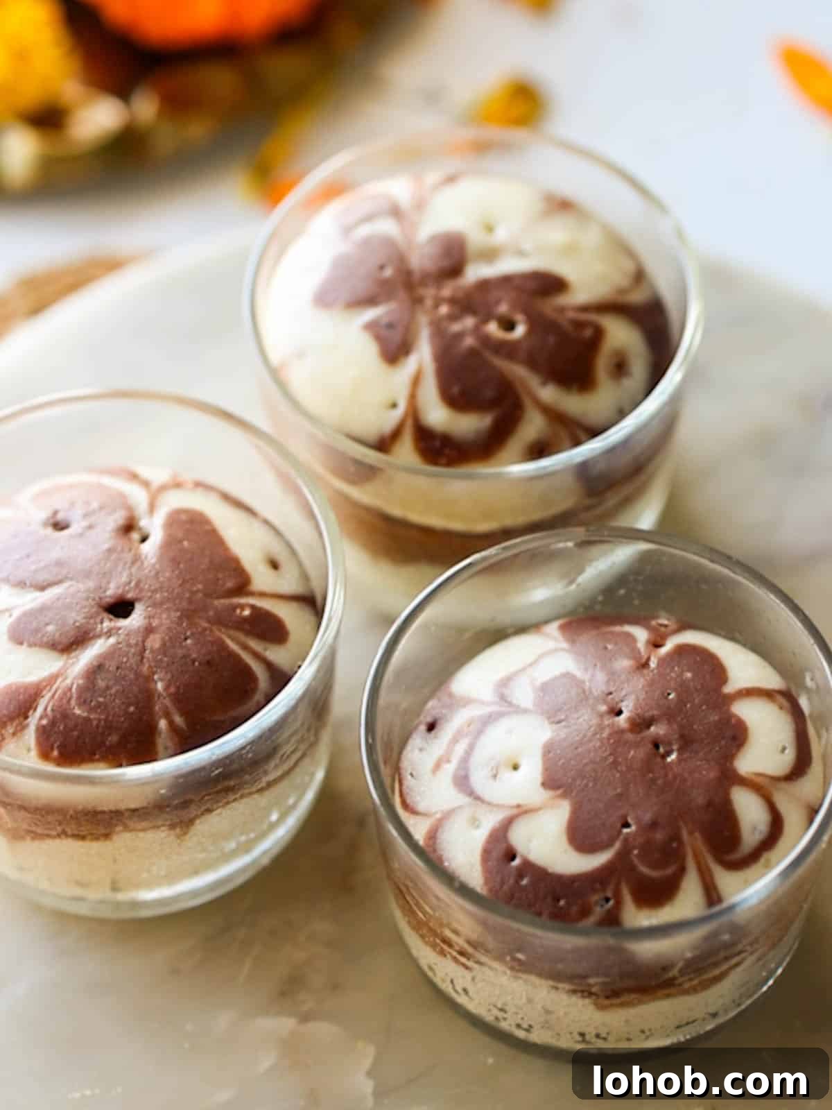 Eggless Marble Cake Without Oven or Microwave — Simple Recipe 2 mini eggless marble cakes placed on a white board