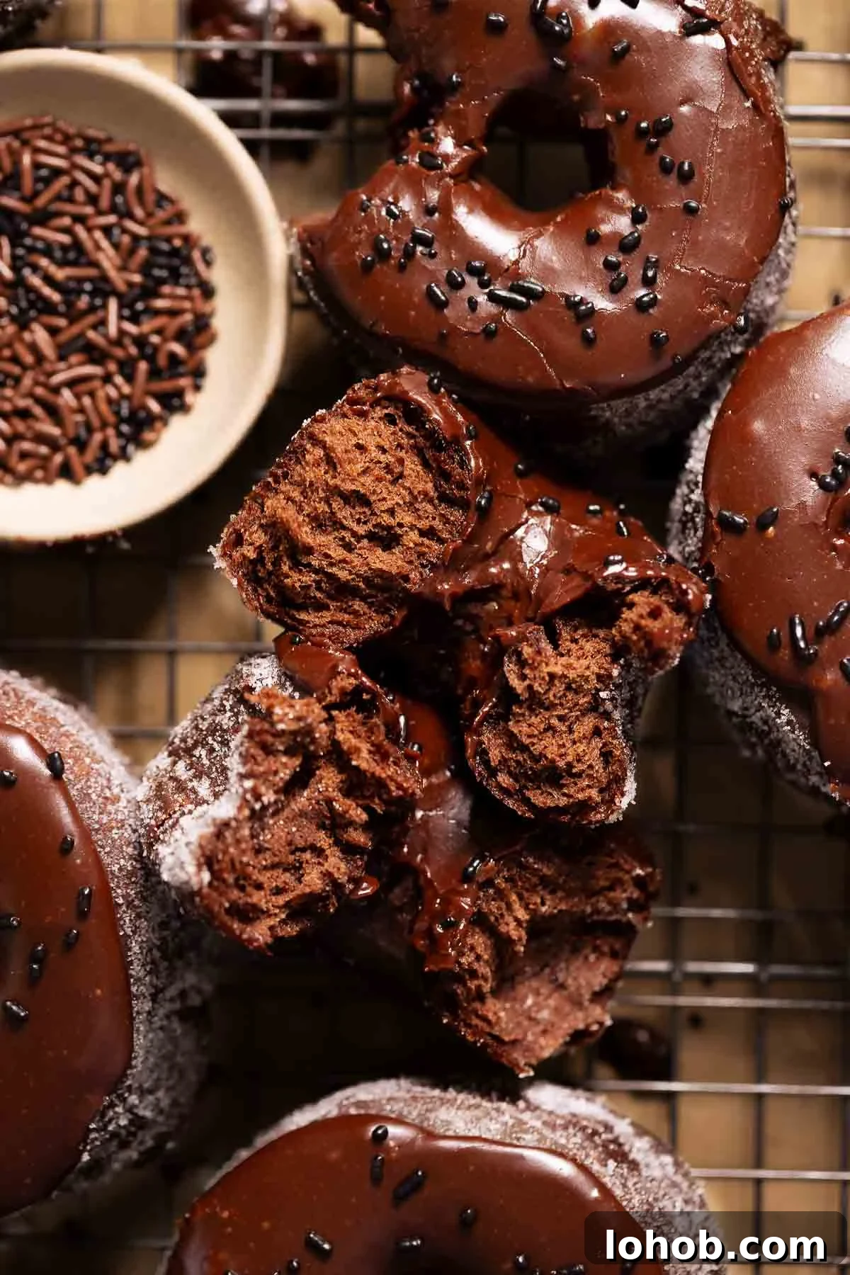 A chocolate doughnut broken in half to show the soft and fluffy texture.