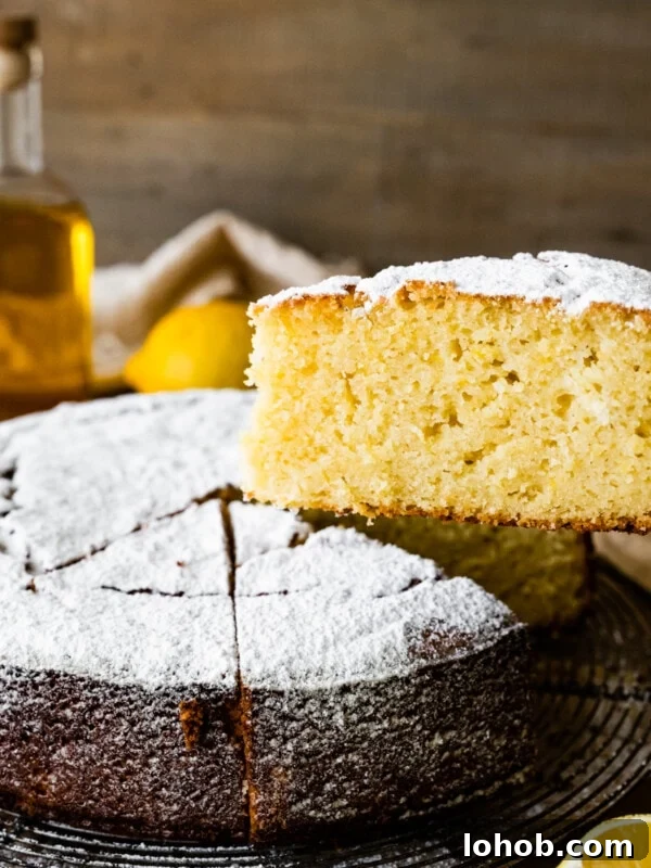 Slice being removed from a lemon olive oil cake.