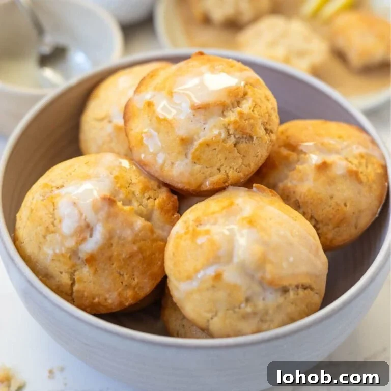 Quick Sourdough Lemon Muffins Recipe for Fresh Morning Bakes 11 Bowl of sourdough lemon muffins topped with lemon glaze.