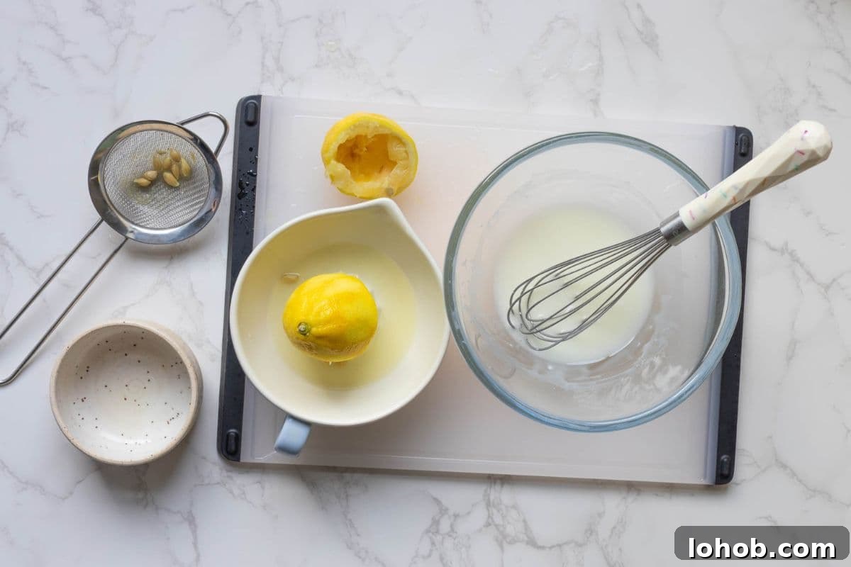 Quick Sourdough Lemon Muffins Recipe for Fresh Morning Bakes 8 Fresh lemon juice being whisked with powdered sugar to make lemon glaze.
