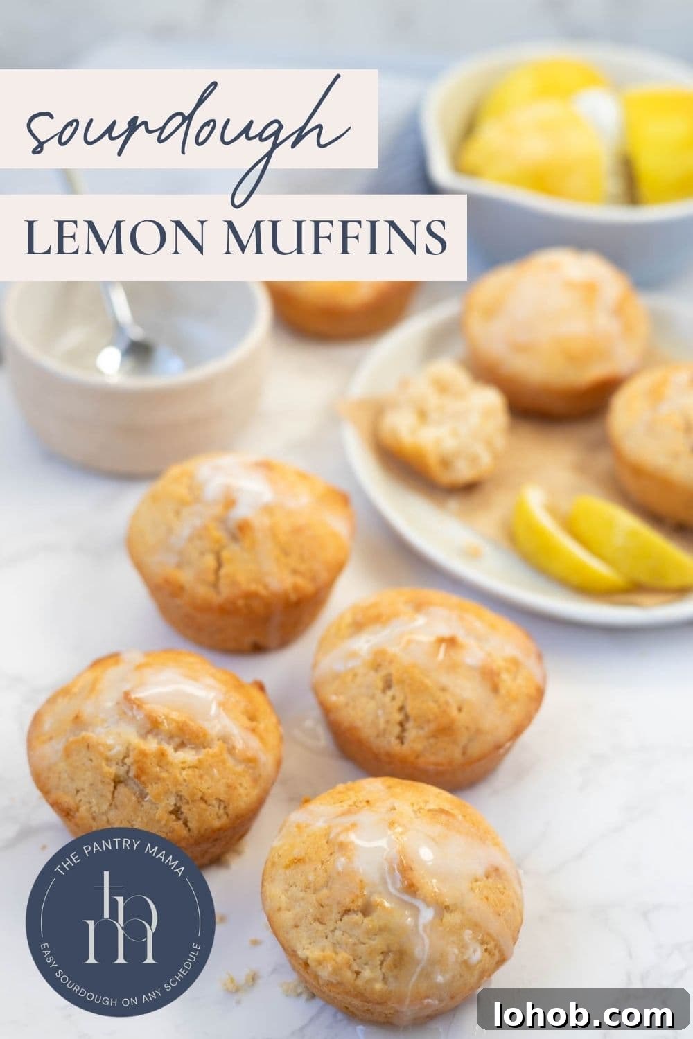 Quick Sourdough Lemon Muffins Recipe for Fresh Morning Bakes 10 Sourdough lemon muffins with lemon glaze arranged on a countertop with lemon slices and text overlay for a Pinterest Pin.