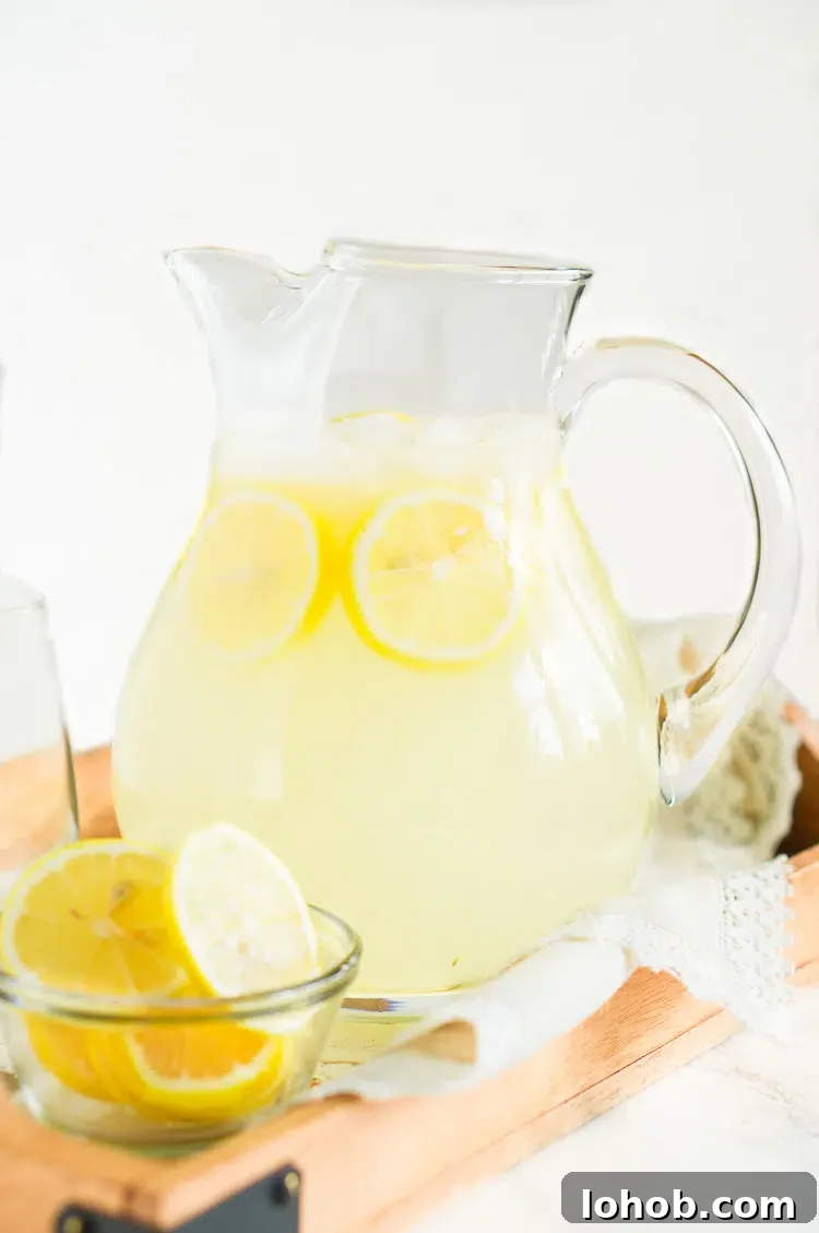 Refreshing Homemade Lemonade Recipe for Perfect Summer Sips 2 Homemade Lemonade with real lemons in a glass pitcher