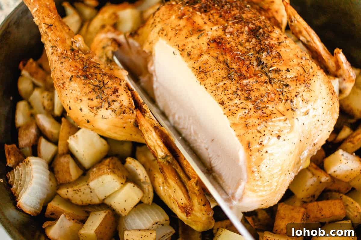 Cast iron roasted chicken with red potatoes with a slice.