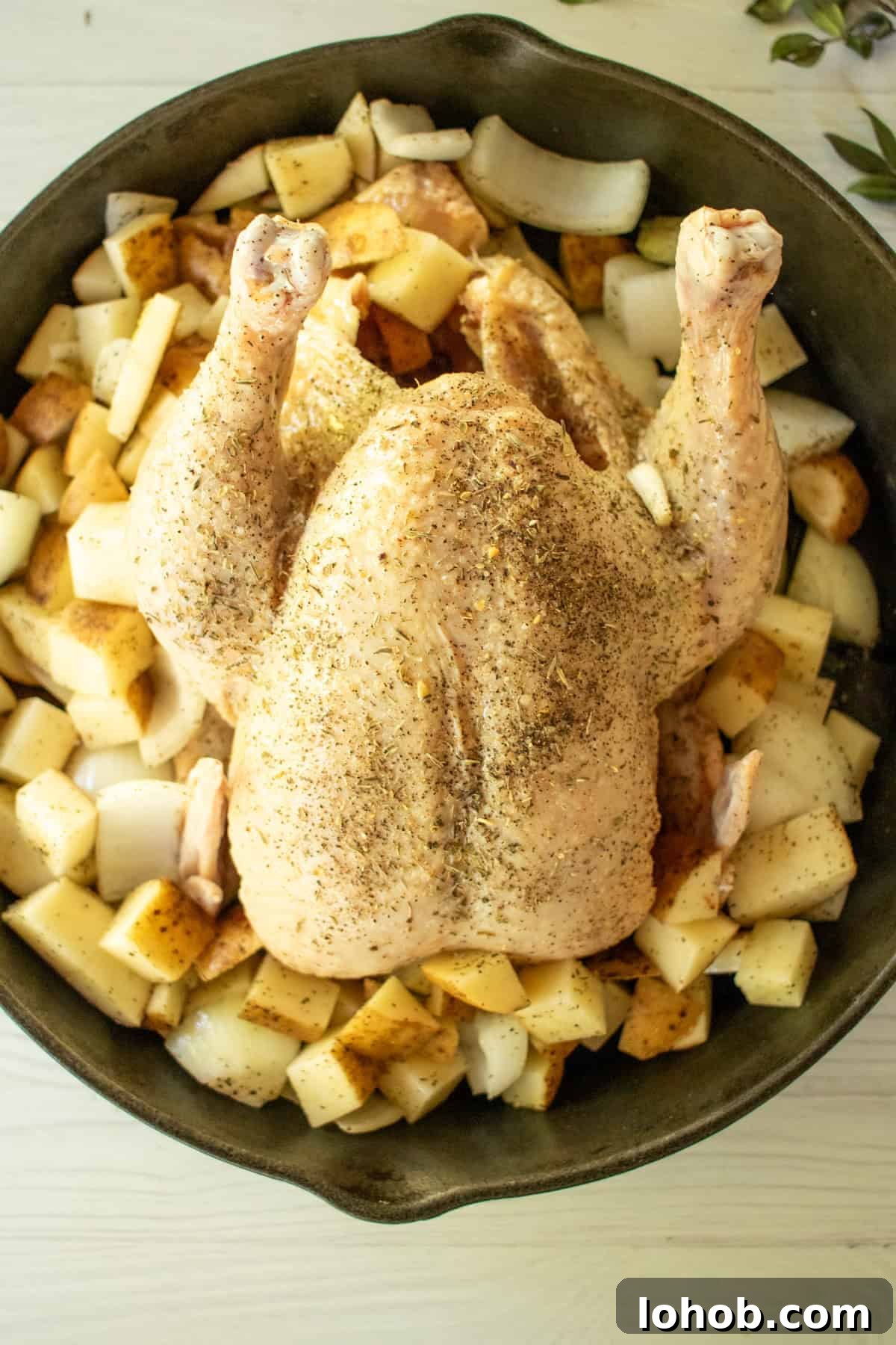 Place potatoes and onions around the chicken.