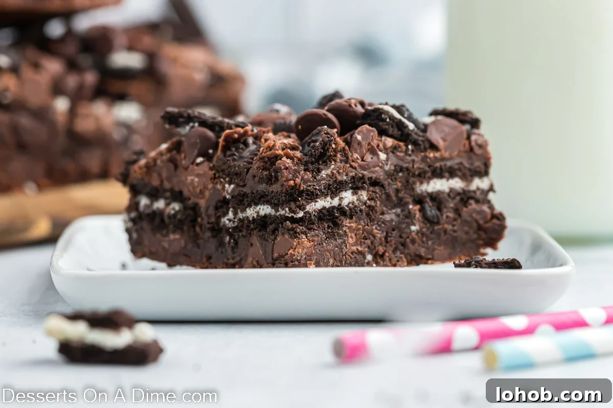 Fudgy Oreo Brownies Recipe with Creamy Cookie Filling 2 Oreo Brownie cut into bars and served on a white plate.