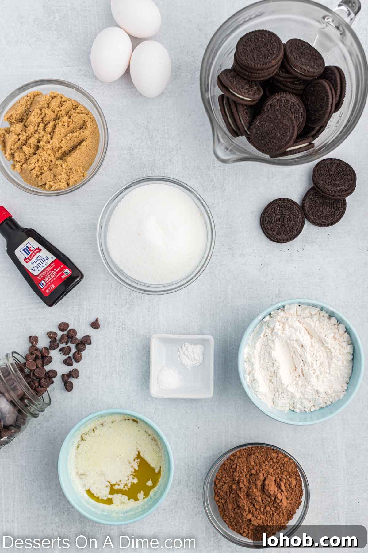 Fudgy Oreo Brownies Recipe with Creamy Cookie Filling 3 Ingredients needed - sugar, brown sugar, cocoa powder, flour, salt, baking powder, eggs, butter, vanilla, chocolate chips, oreos