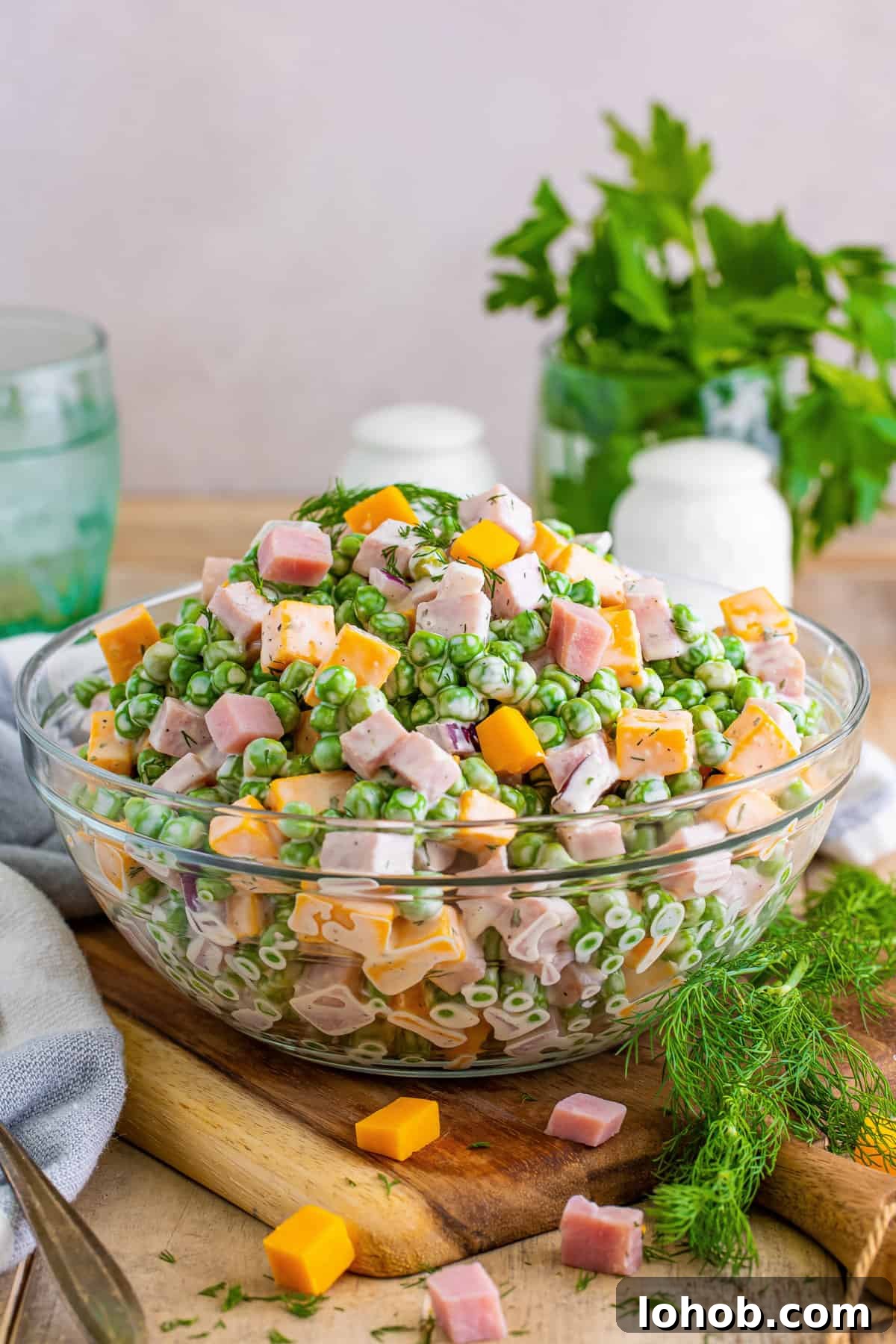 Ham and pea salad with cheese, red onion, and a creamy dressing.