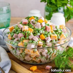 Ham and pea salad with cheese, red onion, and a creamy dressing.