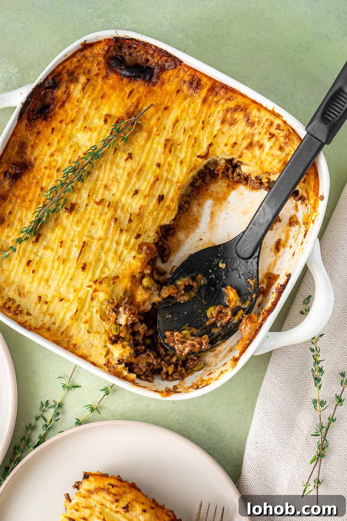 Classic Cottage Pie Recipe with Savory Beef and Mashed Potato Top 4 The cottage pie with a large serving spoon.