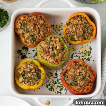 Colorful baked ground turkey stuffed peppers with quinoa and herbs.