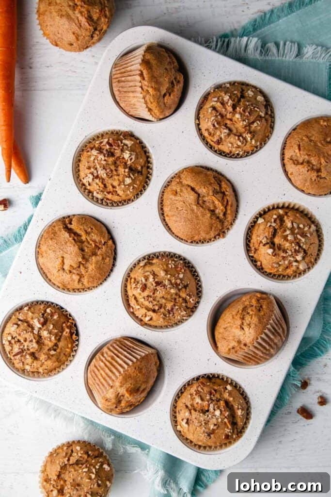 Dairy-Free Gluten-Free Carrot Muffins – Moist, Allergy-Friendly 6 The baked gf carrot muffins in a white speckled tin. Some muffins tilted on side.