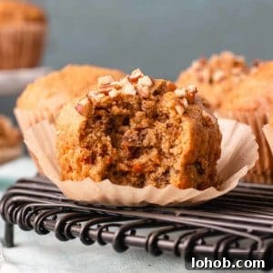 Dairy-Free Gluten-Free Carrot Muffins – Moist, Allergy-Friendly 7 Gluten-free carrot muffin with bite taken to reveal texture.