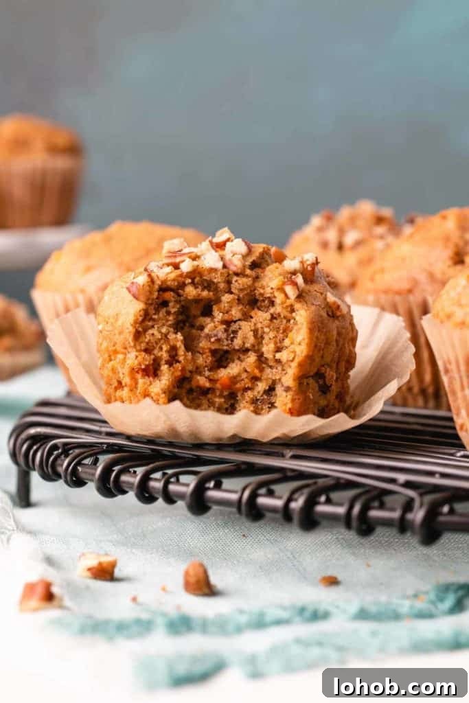 Dairy-Free Gluten-Free Carrot Muffins – Moist, Allergy-Friendly 8 A gluten-free carrot muffin with a bite removed to show inside texture.