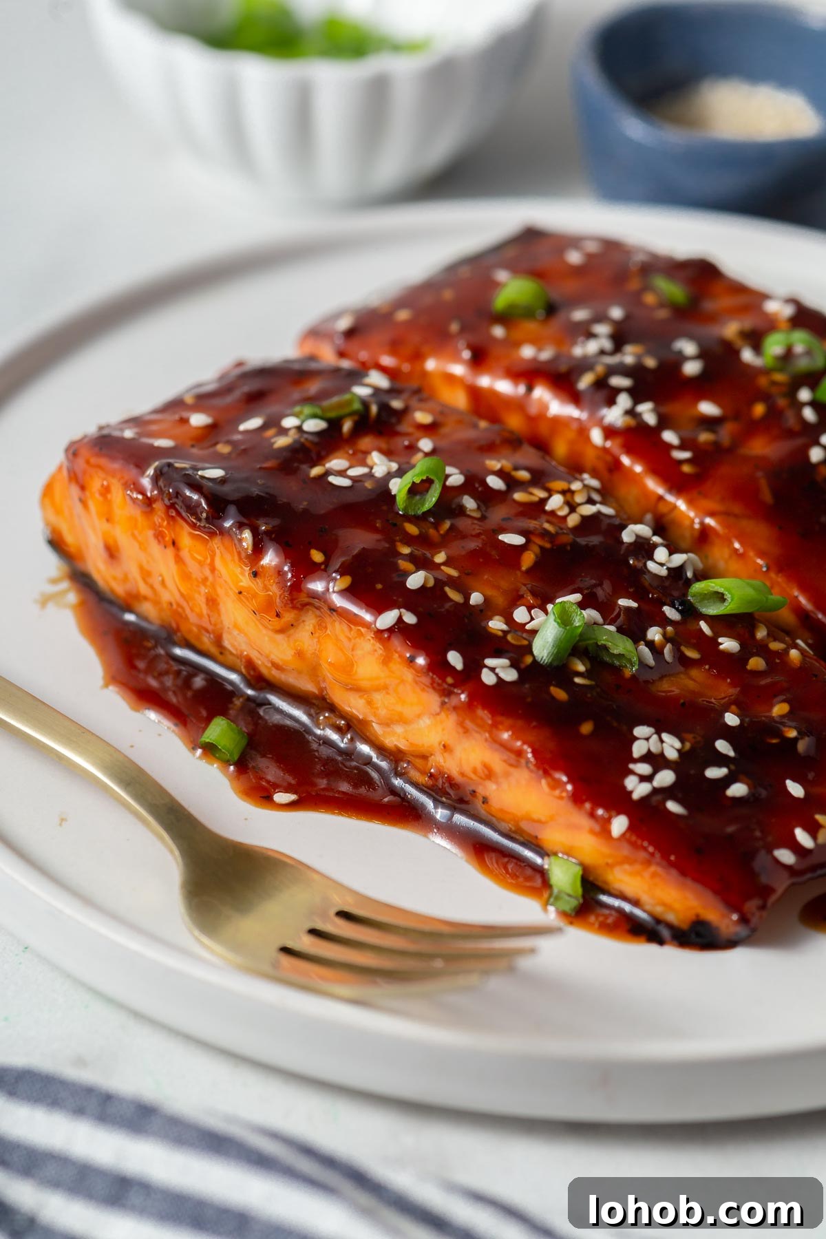 Crispy Air Fryer Teriyaki Salmon 2 air fryer teriyaki salmon on a plate with a fork.
