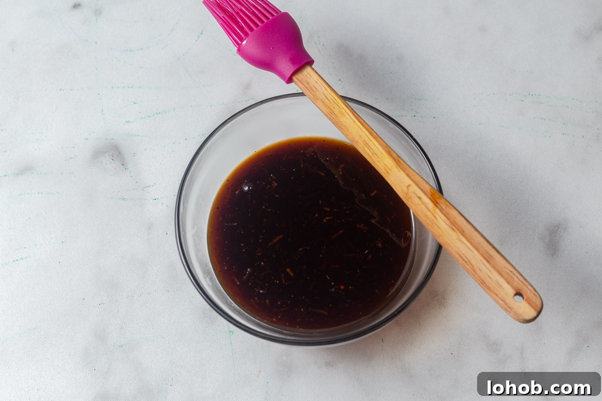 Crispy Air Fryer Teriyaki Salmon 8 cooked teriyaki sauce with a pastry brush.