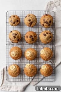 Twelve banana muffins cooling on a wire rack.