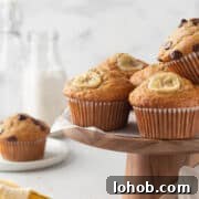 Gluten-free banana muffins on a wooden cake stand.