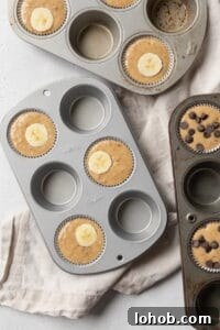 Banana muffin batter in a muffin pan.
