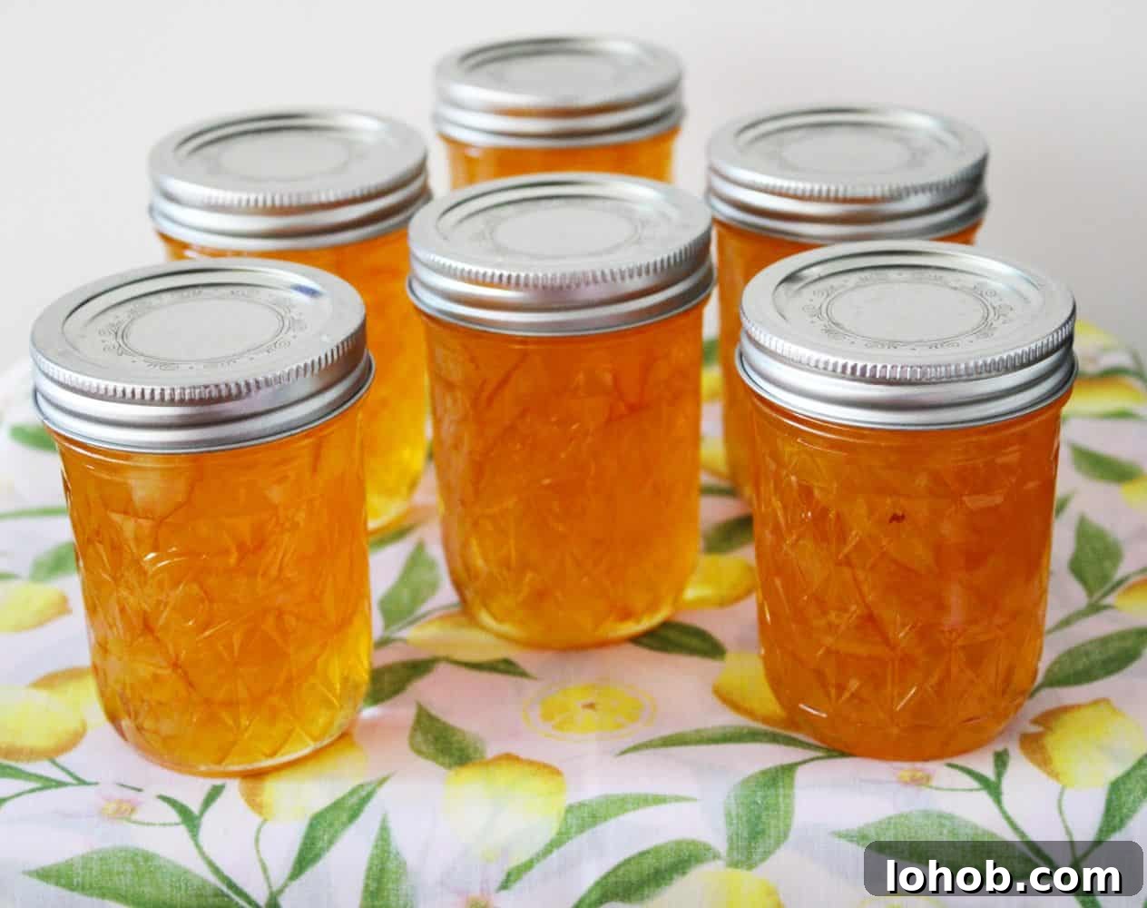 3-Ingredient Lemon Marmalade Recipe Made from Scratch 6 Six jars of Lemon Marmalade on a lemon cloth.
