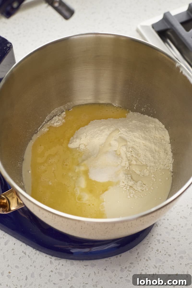 Fluffy Sourdough Discard Hamburger Buns You Can Make at Home 4 Ingredients in the bowl of a stand mixer.