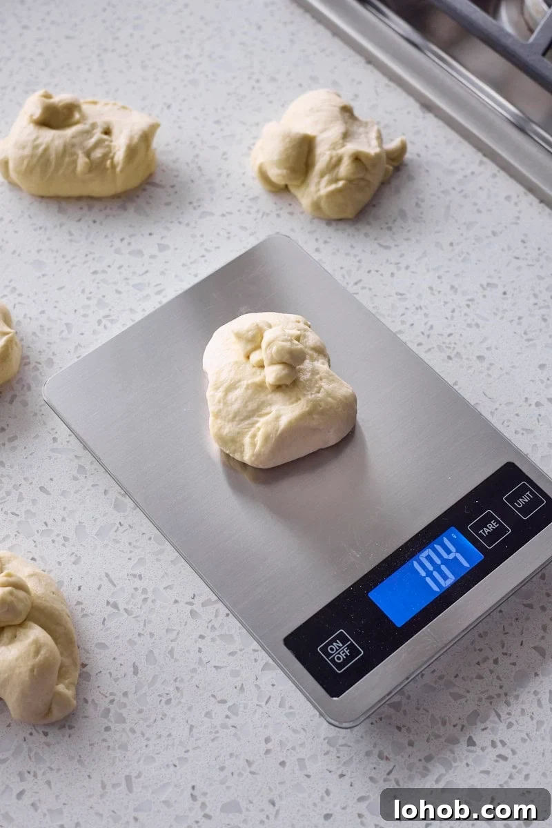 Fluffy Sourdough Discard Hamburger Buns You Can Make at Home 6 Dough being weighed on a kitchen scale.