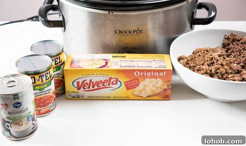 Crock Pot Queso with Beef and Sausage: Slow Cooker Party Dip 3 crock pot with velveeta, rotel, cream of mushroom soup, ground beef and ground sausage for slow cooker queso cheese dip
