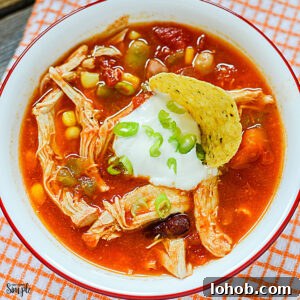 Chicken Taco Soup in bowl topped with sour cream and green onions