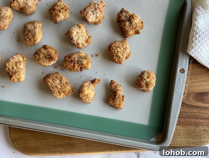 Chick-fil-A Chicken Minis Copycat Recipe — Soft, Tender Bites 6 Frozen chicken nuggets on a baking sheet for making homemade Chick-fil-A chicken mini sandwiches, an easy copycat recipe for breakfast.