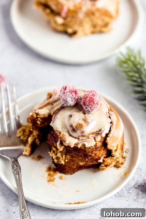 half eaten gingerbread cinnamon roll on an appetizer plate