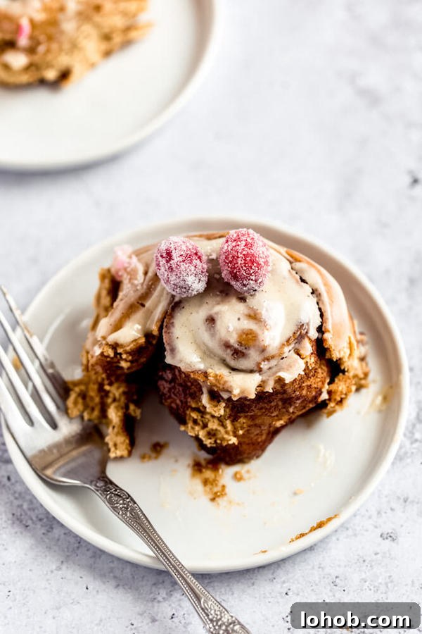half eaten gingerbread cinnamon roll on an appetizer plate