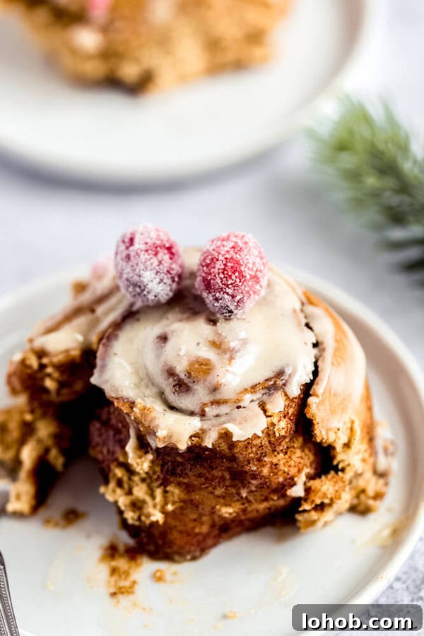 half eaten gingerbread cinnamon roll on an appetizer plate