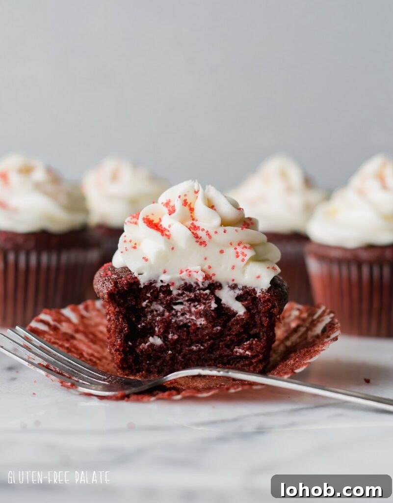Gluten-Free Red Velvet Cupcakes Recipe for Moist, Fluffy Results 6 Red velvet cupcake topped with white frosting and red sugar, with a bite taken out and a fork. Photo by Gluten-Free Palate.